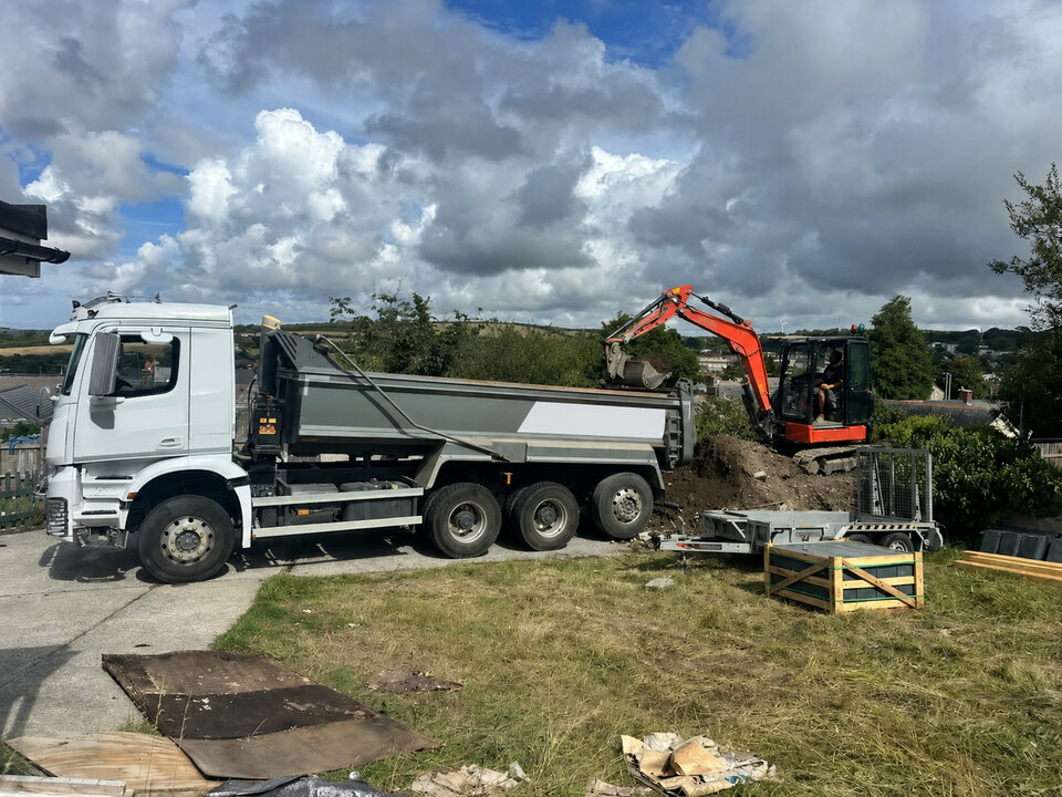 Excavator loading a tipper during site clearance